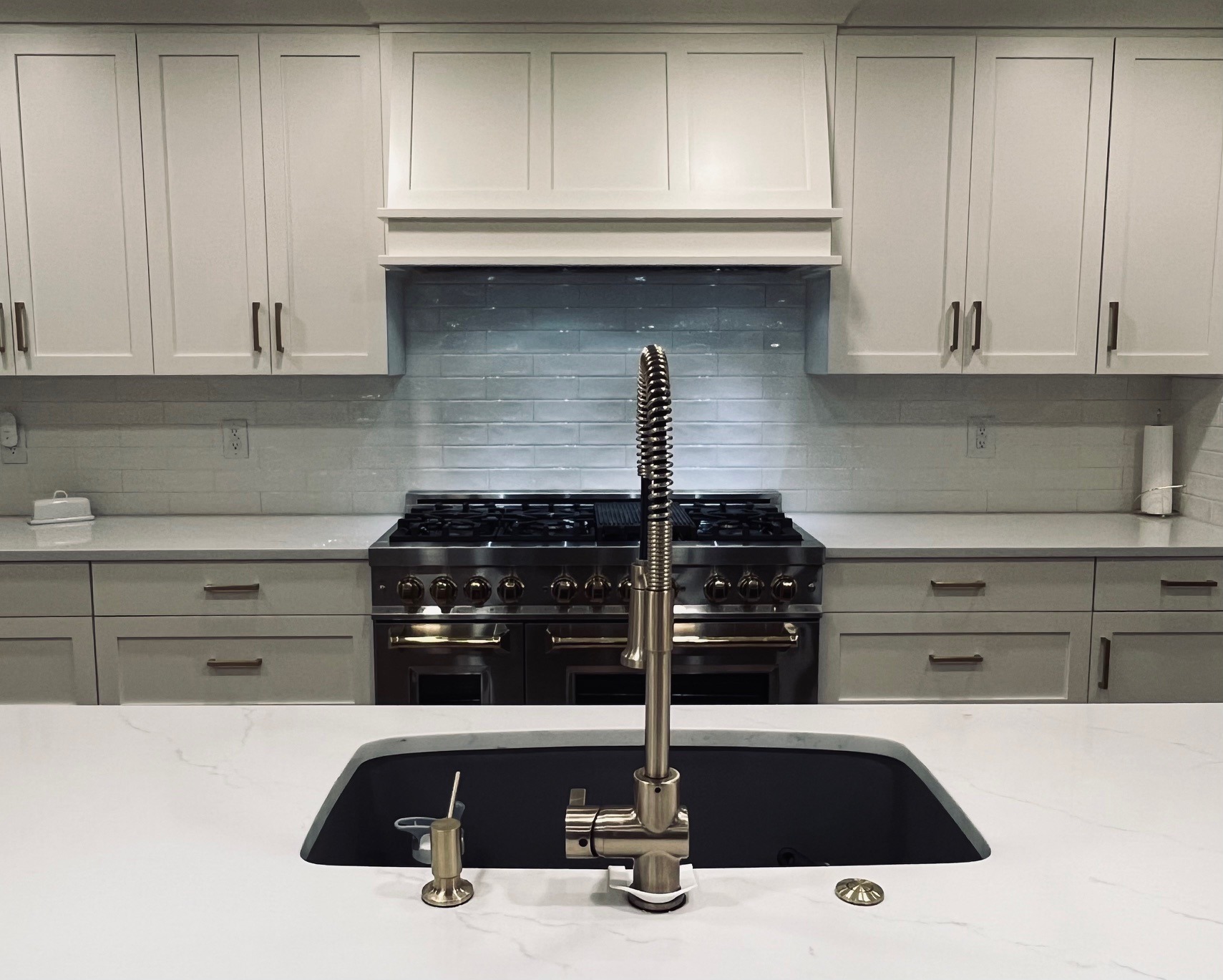 A newly renovated kitchen shines in cream and light blue tones.